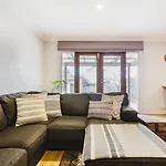 \'Tangerine Gleam\' Cheerful Inner-City Family Abode